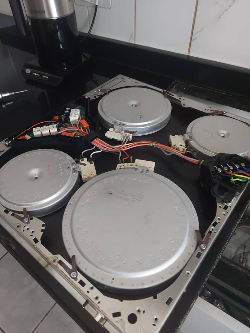 Ceramic hob with its glass top removed, exposing the heating elements
